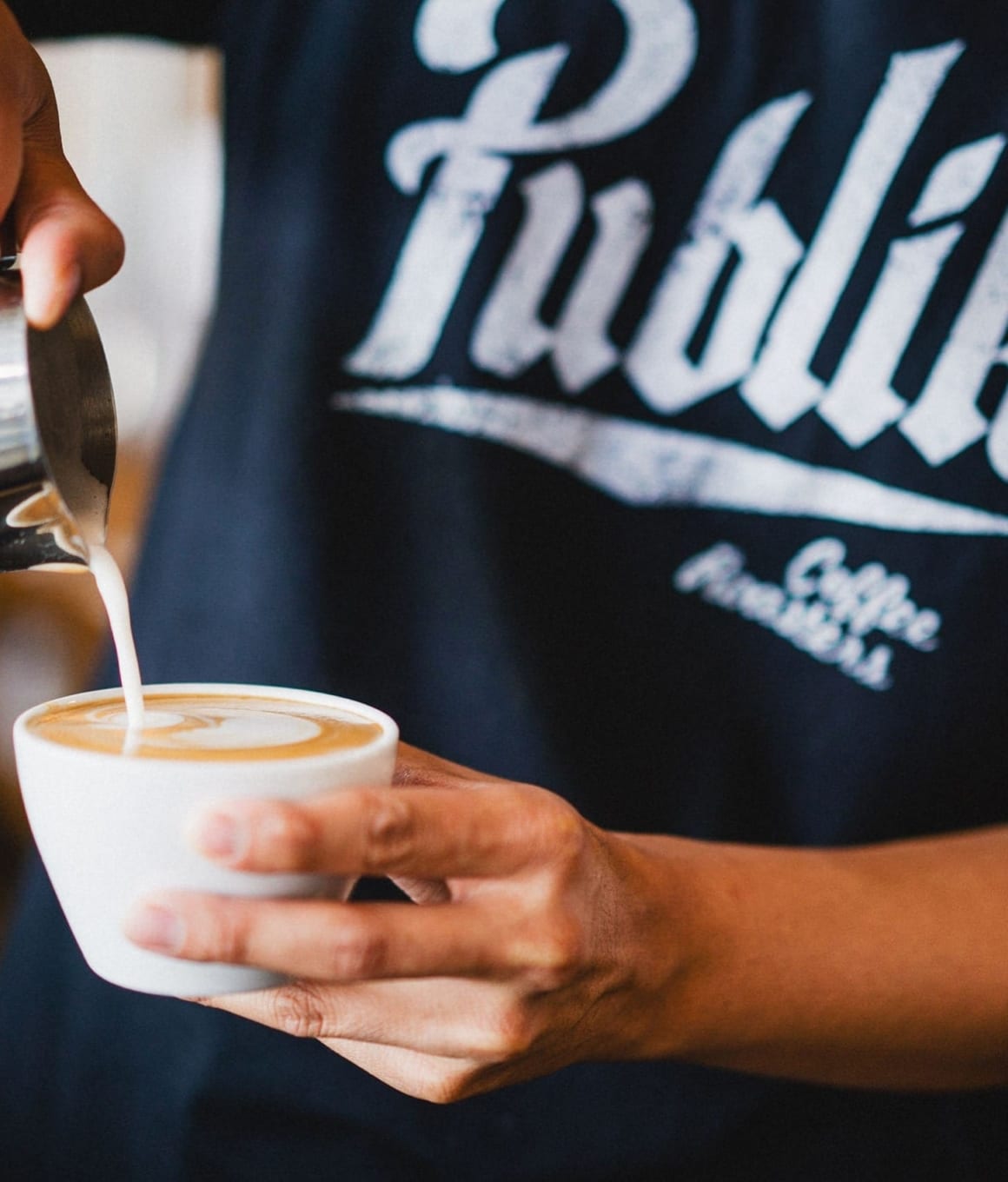 A latte being poured at Publik near Avia apartments