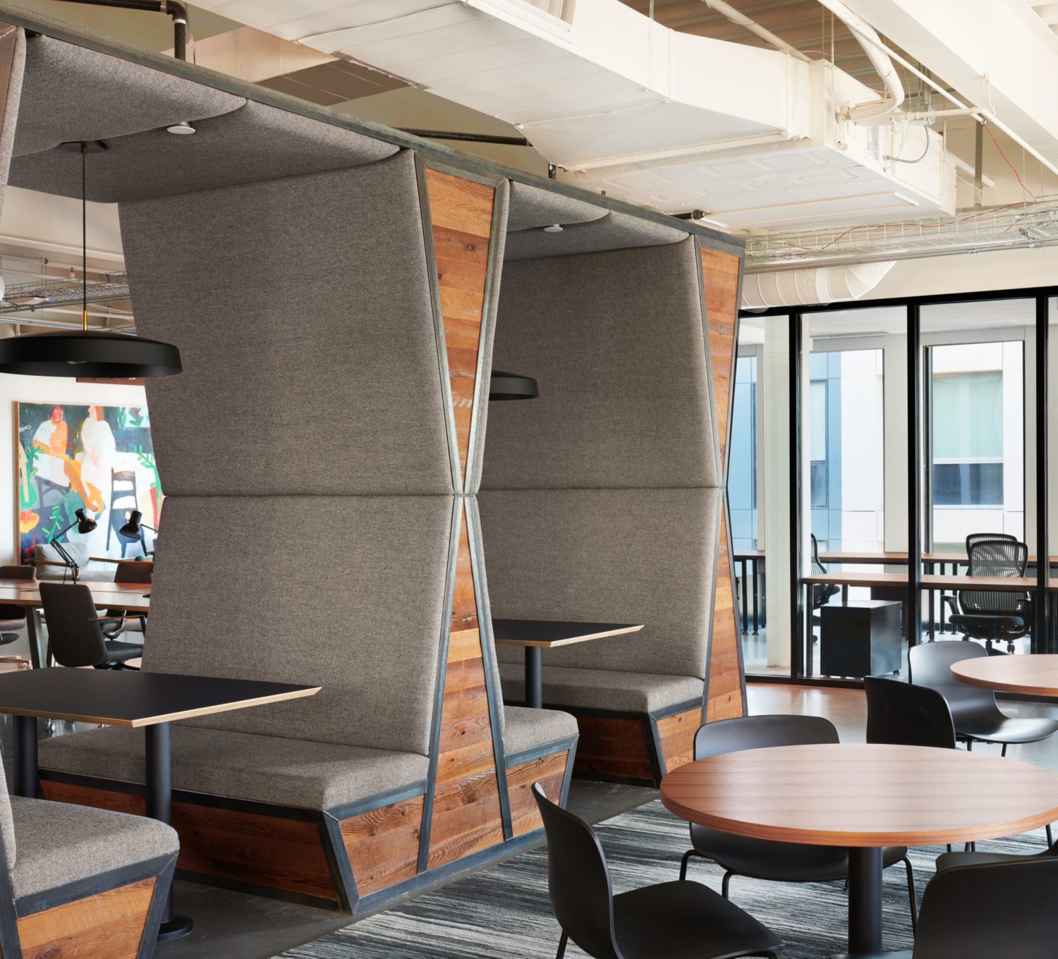 Cushioned seating, private offices, and open desk areas at The Shop Workspace