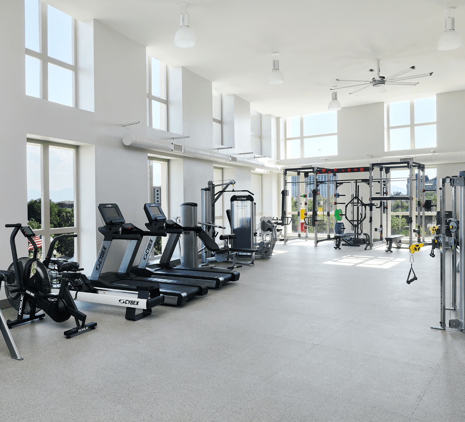 Fitness center with treadmills, pelotons, and free weights.