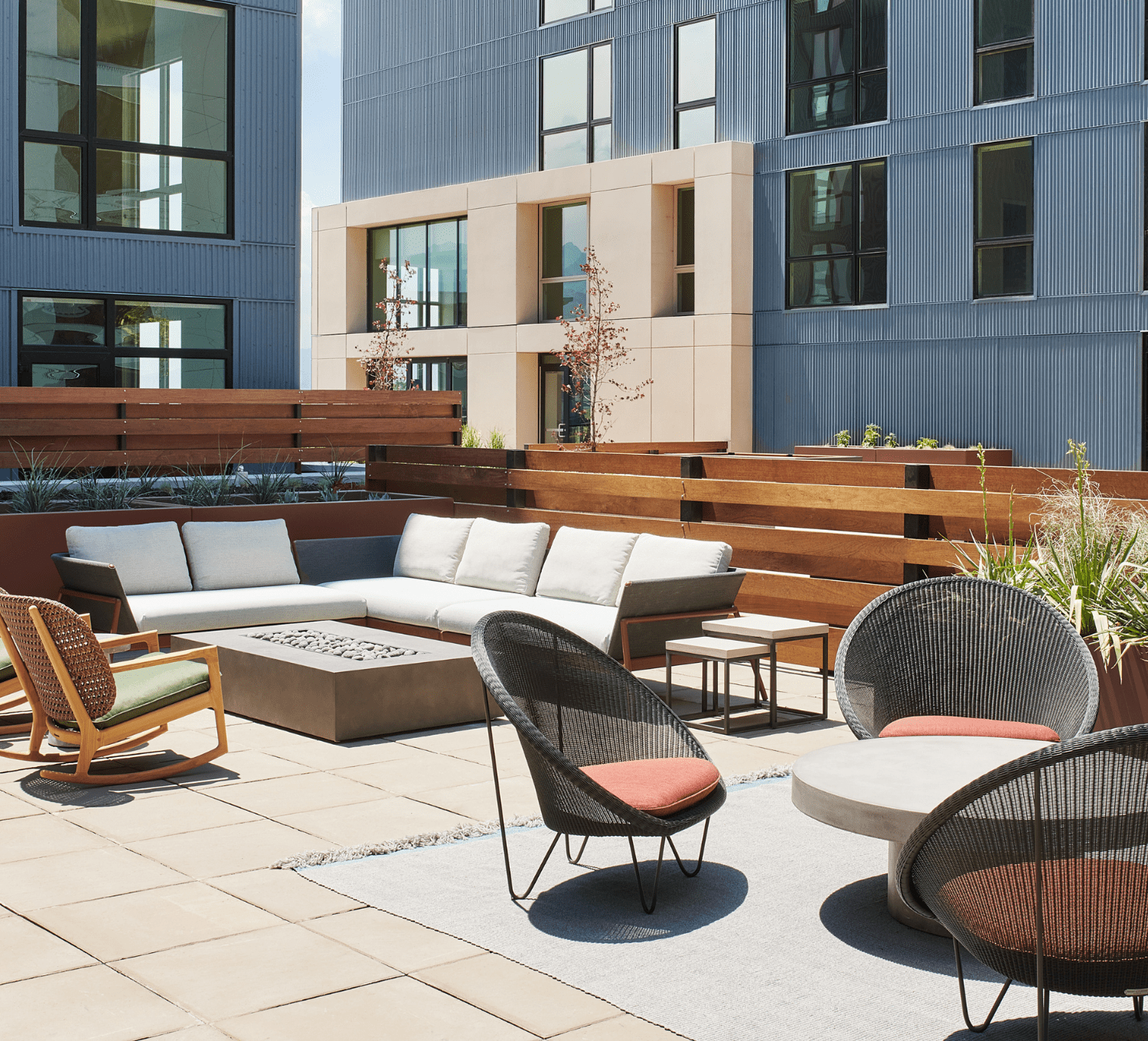 Courtyard patio with cushioned lounge seats and firepit
