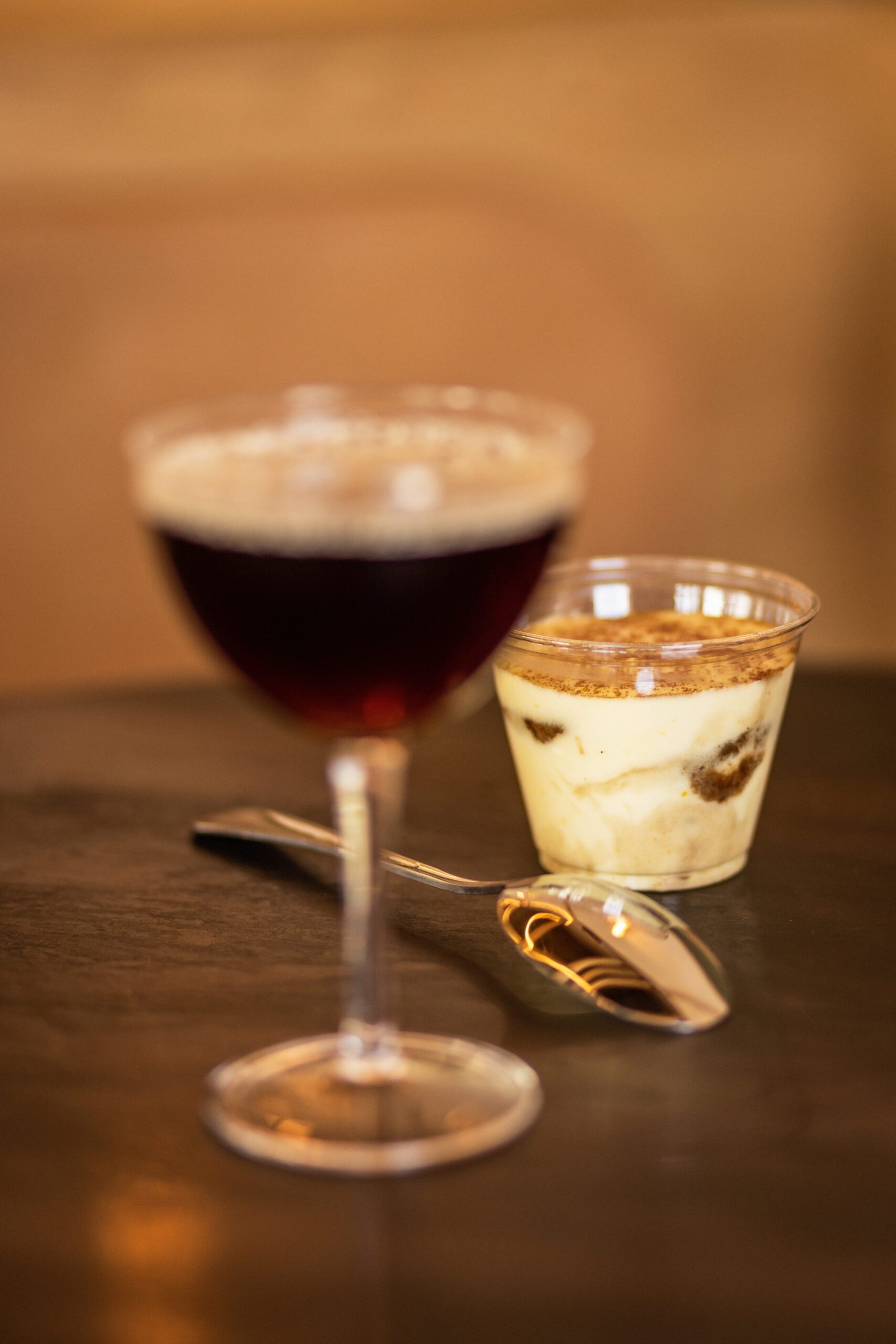 Glasses filled with espresso parfait and a spoon in the middle